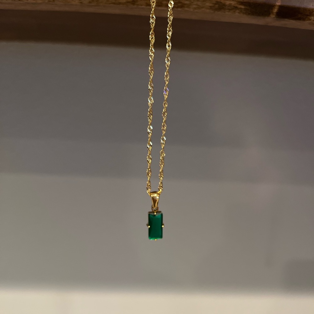 Gold chain with green pendant
